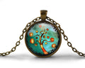 Funky abstract tree art pendant necklace, aqua blue background, orange and yellow accents, handmade in Chattanooga, TN in the USA