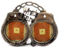 Small, double picture frame in the shape of hand cuffs with the words "What a pair" at the top pf5