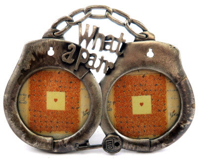 Small, double picture frame in the shape of hand cuffs with the words "What a pair" at the top pf5